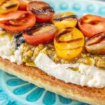 Bruschetta con burrata patè di olive verdi ciliegino e aceto balsamico